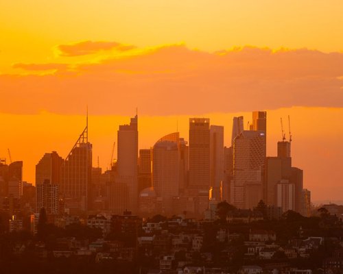 Cinematic panoramic view of an Australian city at twilight, setting the scene for urban leisure.